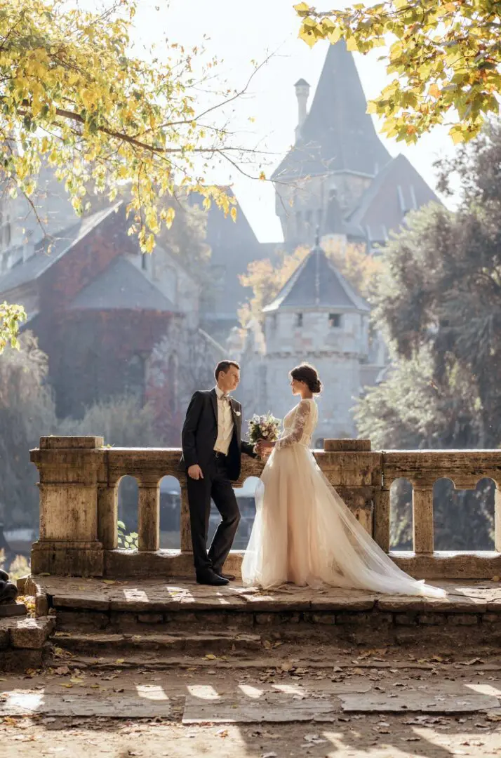 A man and woman standing on the side of a bridge.