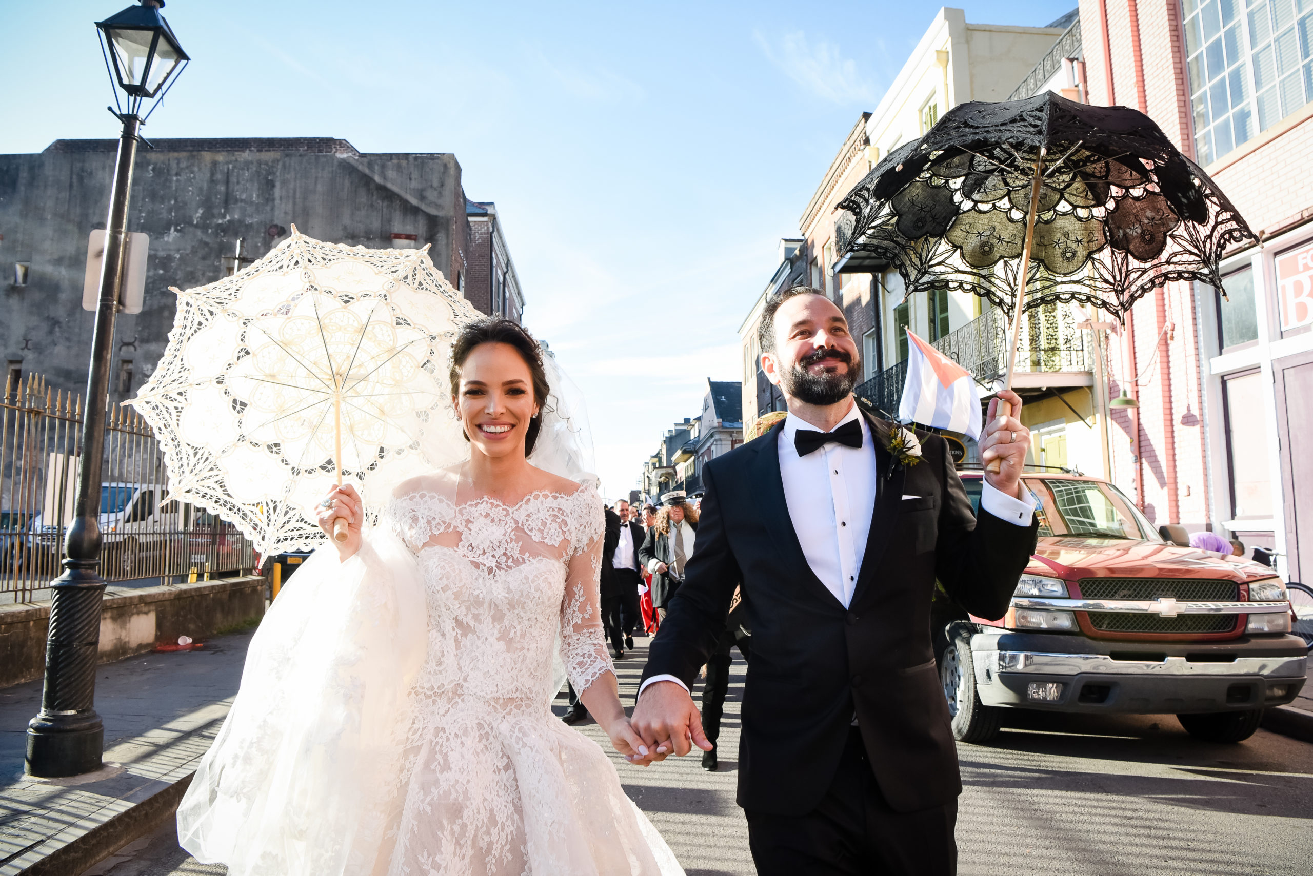 A bride and groom walking down the street