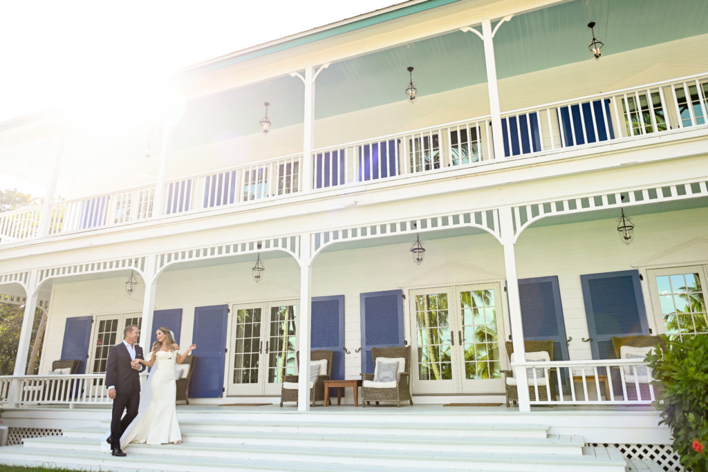 A couple walking down the steps of their wedding venue.