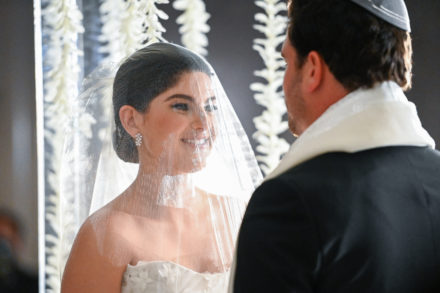 A bride and groom are looking at each other.