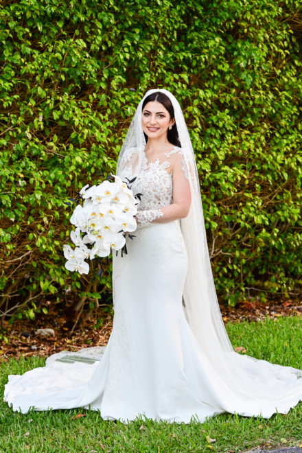 A bride in her wedding dress holding flowers