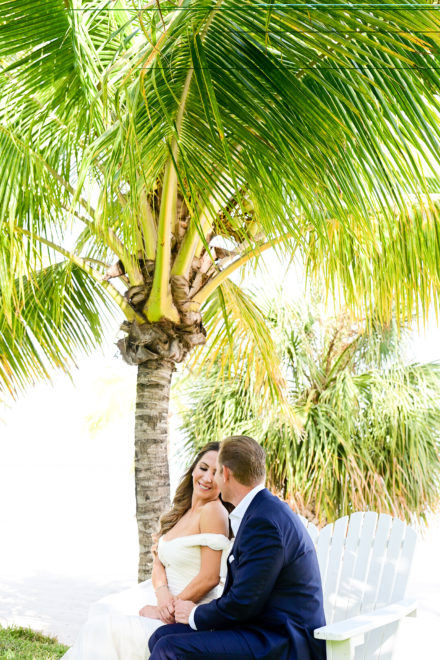 A bride and groom under the palm tree
