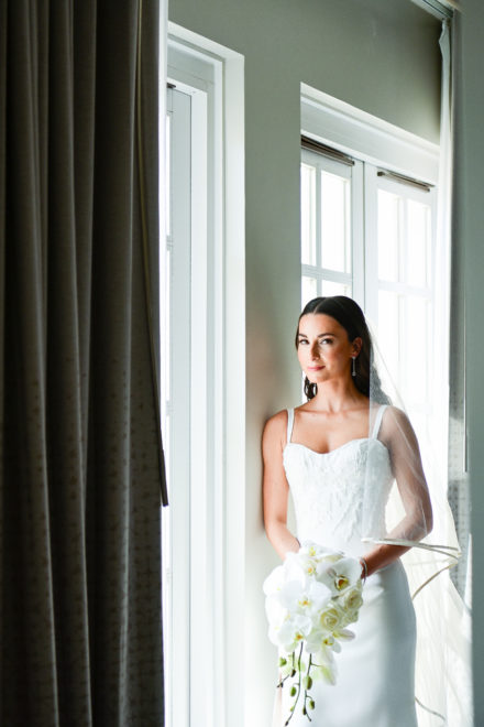 A bride standing in front of the window