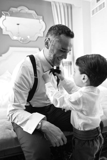 A man and his son getting ready for their wedding.
