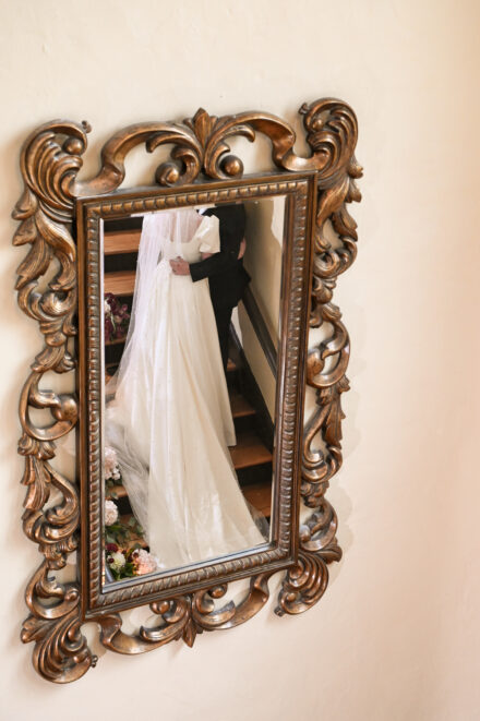 A mirror with a bride and groom in it