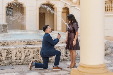 A man kneeling down to propose to his girlfriend.