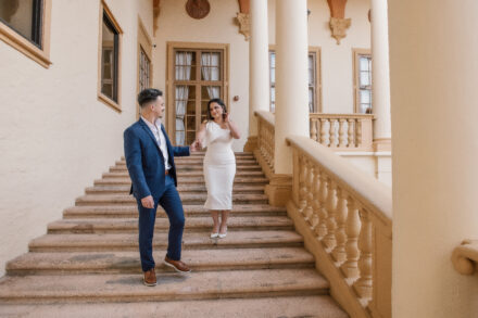A man and woman are standing on the steps.
