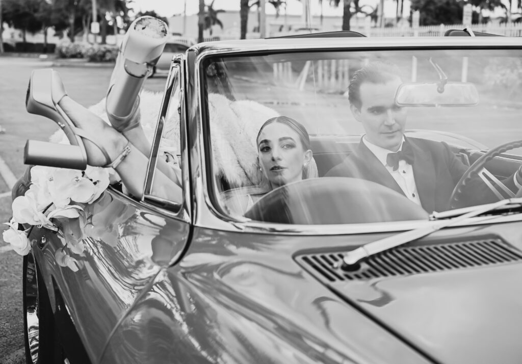 A man and woman in the back of a car.